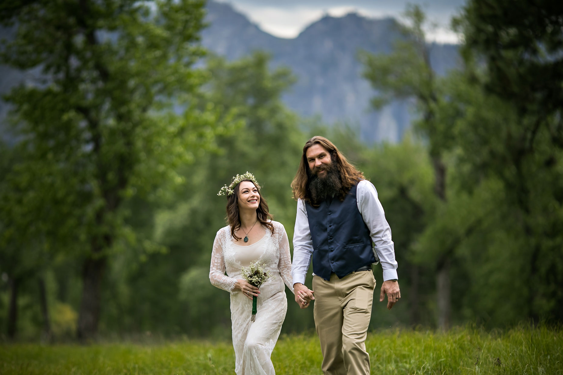 Bride & groom walking in Yosemite during green spring,