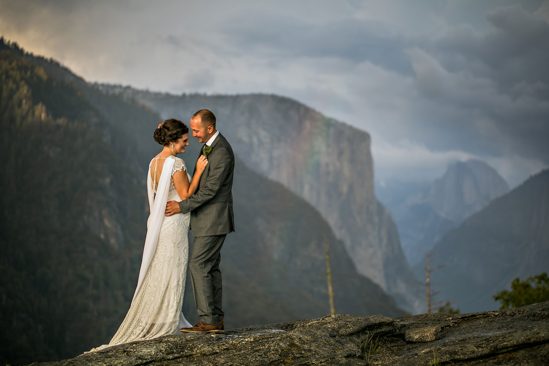 Wedding couple portrait with rainbow in Yosemite.
