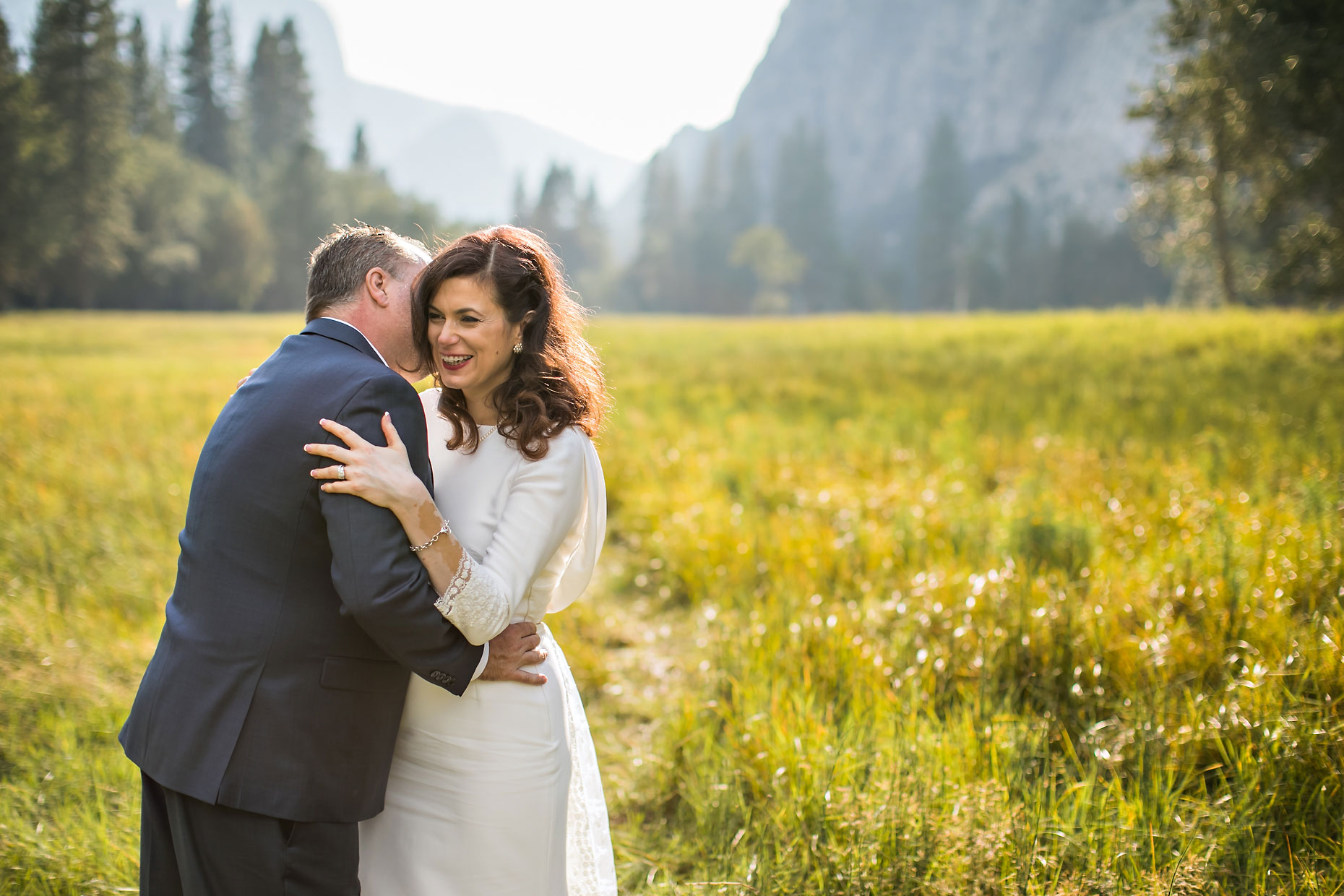 Joyful wedding couple in a meadow in Yosemite.