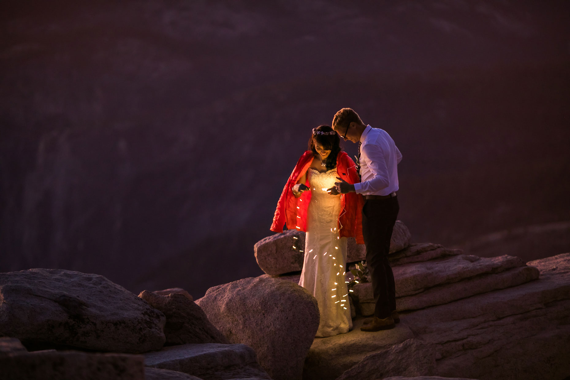 Wedding couple with fairly lights in Yosemite.