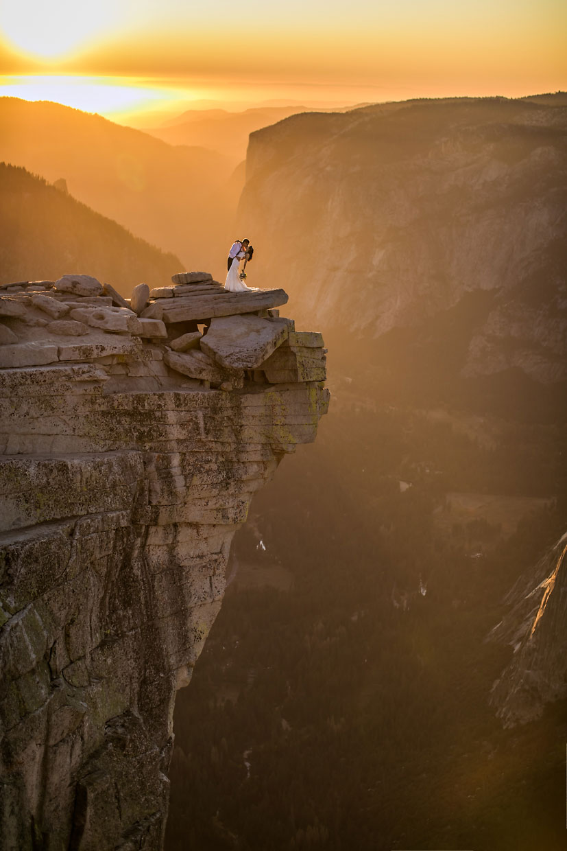 Wedding couple being romantic at sunset in Yosemite.